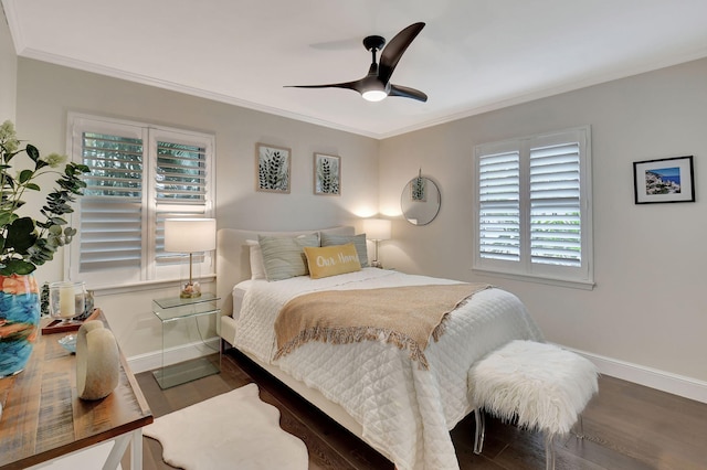 bedroom with ornamental molding, ceiling fan, and dark wood-type flooring