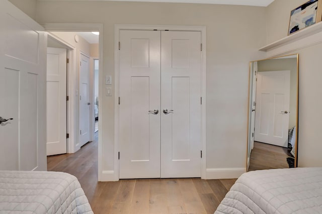 bedroom with a closet and light wood-type flooring