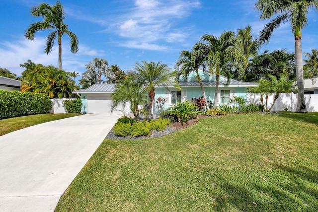 ranch-style home featuring a garage and a front lawn