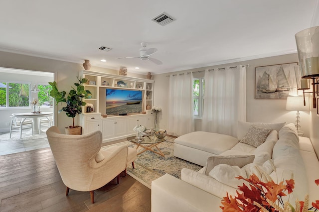 living room with hardwood / wood-style floors, ceiling fan, and a wealth of natural light