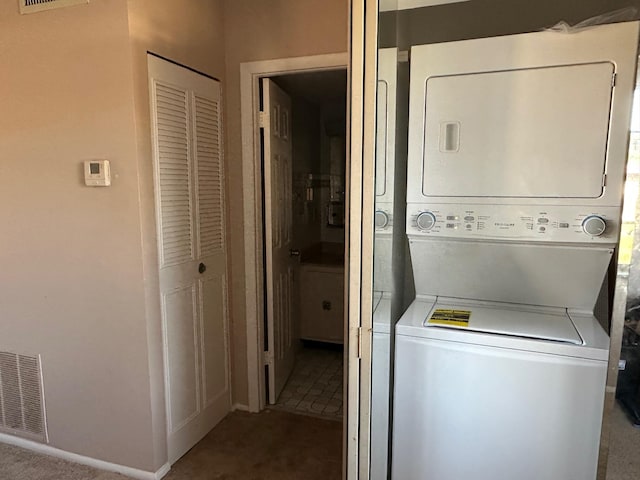 laundry room with stacked washing maching and dryer