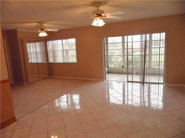 tiled empty room with ceiling fan