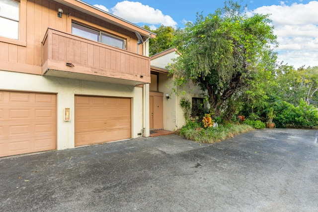 view of front of house with a balcony and a garage