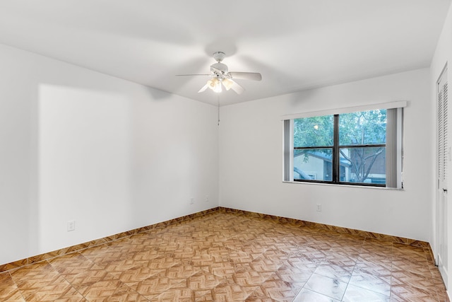 unfurnished room featuring light parquet floors and ceiling fan