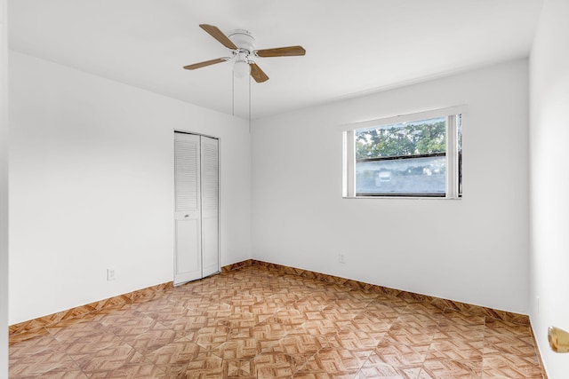 unfurnished room with light parquet flooring and ceiling fan