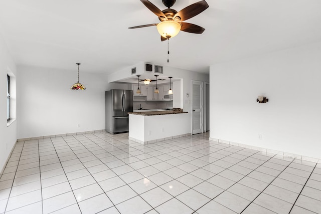 kitchen featuring stainless steel refrigerator, white cabinetry, ceiling fan, kitchen peninsula, and light tile patterned floors