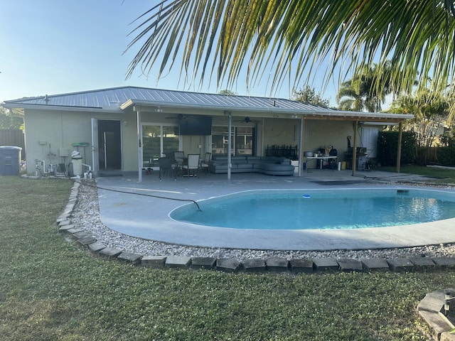 back of property with ceiling fan, an outdoor hangout area, cooling unit, a fenced in pool, and a patio