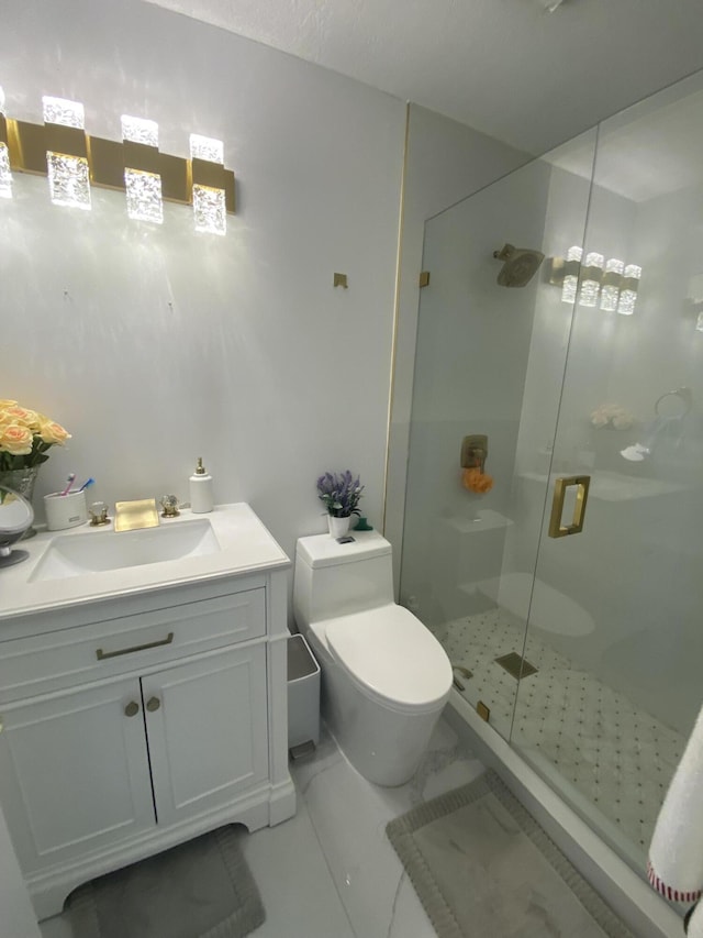 bathroom featuring vanity, toilet, and a shower with shower door