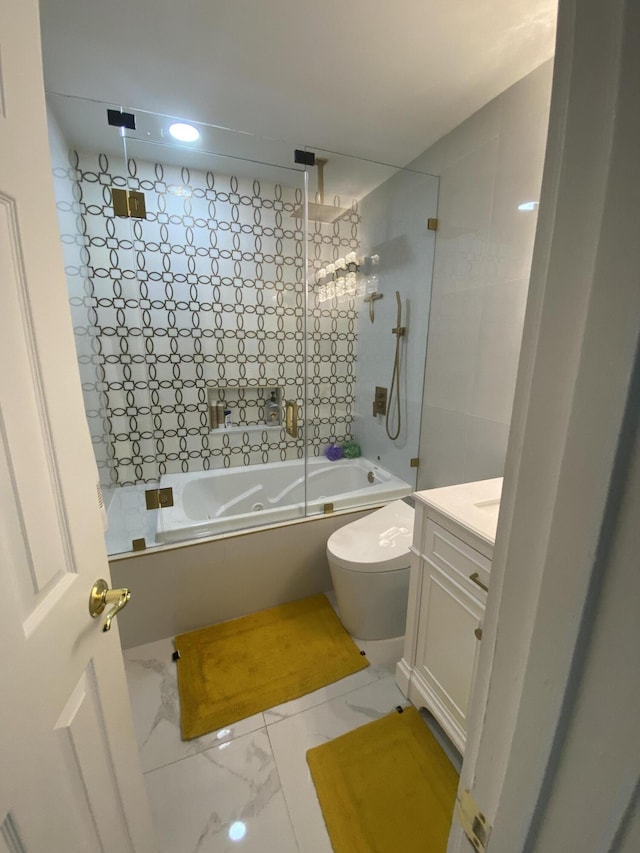 full bathroom featuring vanity, bath / shower combo with glass door, and toilet