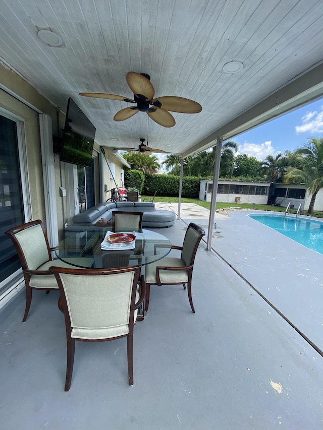 view of patio / terrace with ceiling fan and a fenced in pool