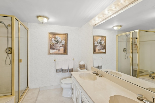 bathroom with toilet, tile patterned flooring, vanity, and walk in shower