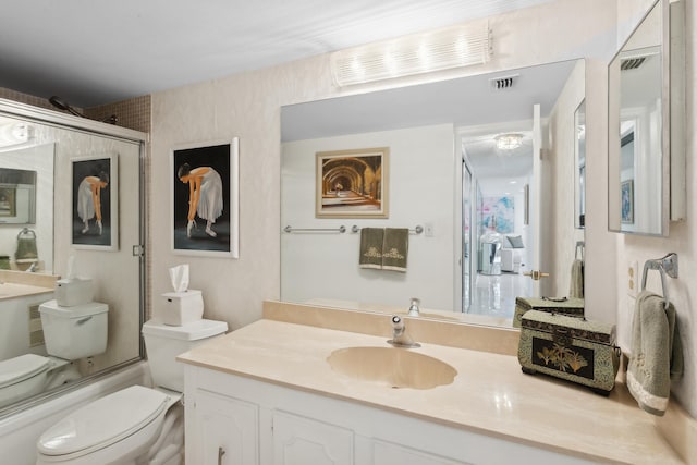 full bathroom with vanity, toilet, and shower / bath combination with glass door