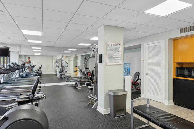 gym featuring a paneled ceiling