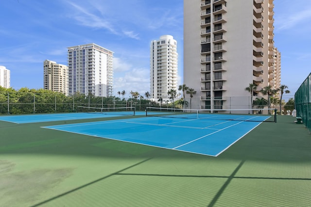 view of tennis court with basketball hoop