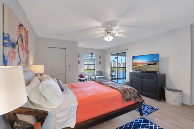 bedroom featuring access to outside, light hardwood / wood-style flooring, a closet, and ceiling fan