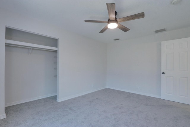 unfurnished bedroom with ceiling fan, a closet, and light carpet