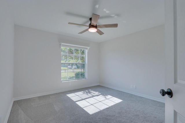 empty room featuring carpet flooring and ceiling fan