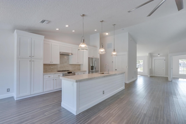 kitchen featuring stainless steel appliances, pendant lighting, a center island with sink, white cabinets, and dark hardwood / wood-style floors