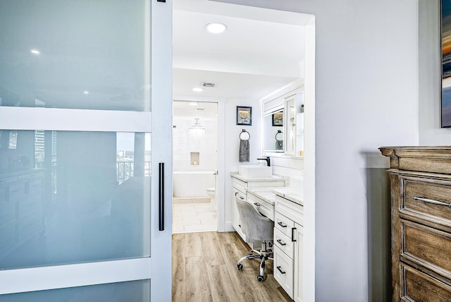 bathroom featuring vanity, toilet, and wood-type flooring