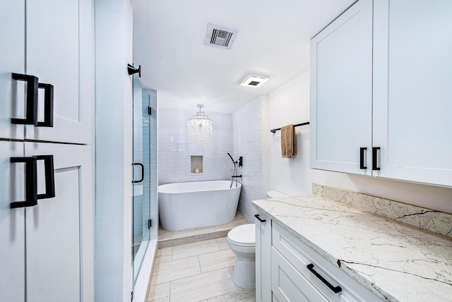 full bathroom featuring toilet, vanity, separate shower and tub, and a notable chandelier