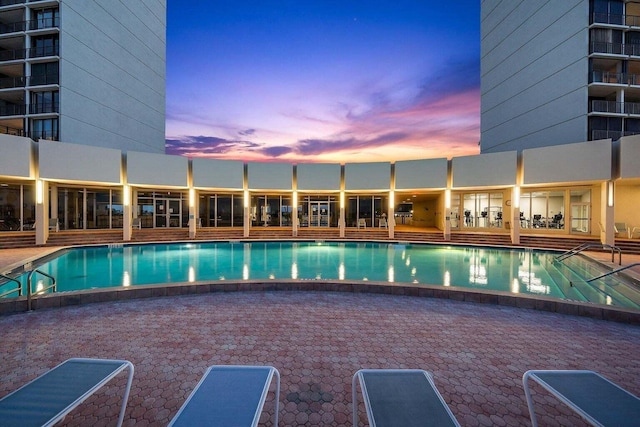 view of pool at dusk