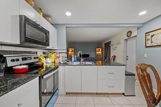 kitchen with white cabinetry, sink, dark stone counters, stainless steel electric range, and light tile patterned flooring