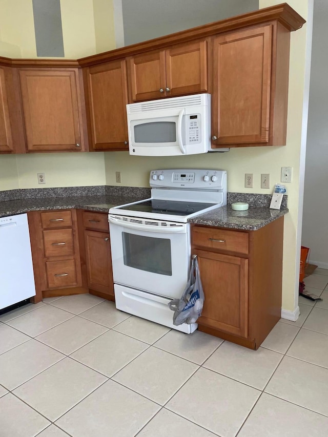 kitchen with white appliances and light tile patterned floors