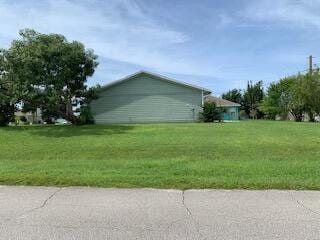 view of side of home with a lawn