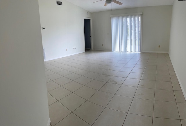 unfurnished room featuring light tile patterned floors, visible vents, baseboards, ceiling fan, and vaulted ceiling