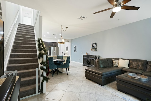 living room featuring ceiling fan and light tile patterned floors