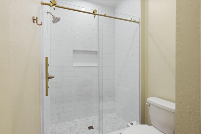 bathroom with toilet and walk in shower