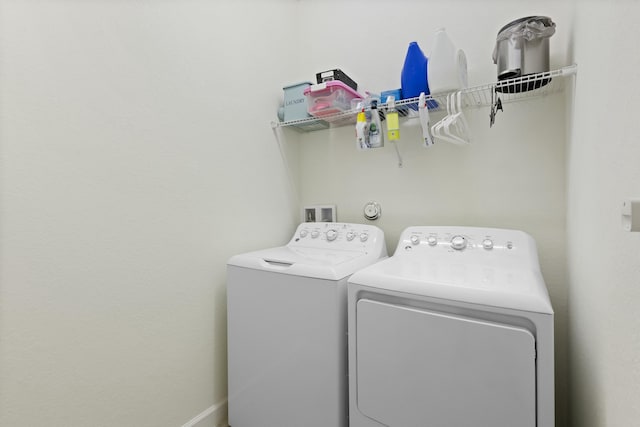 clothes washing area featuring washer and clothes dryer