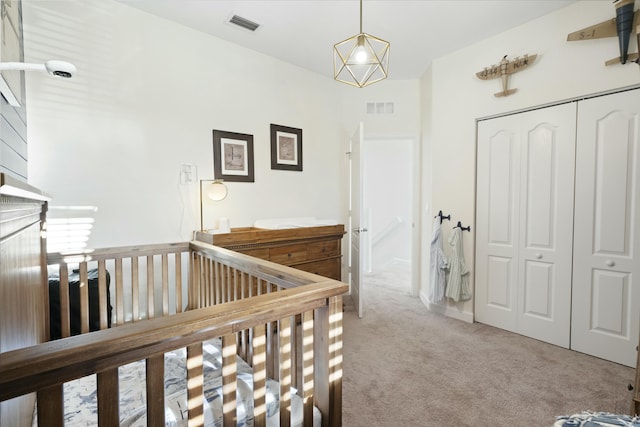 carpeted bedroom featuring a closet and a crib