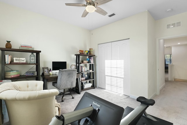 office space with ceiling fan and light carpet