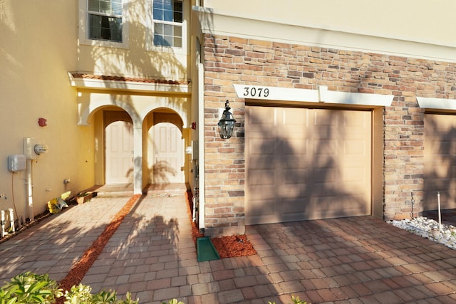 doorway to property featuring a garage