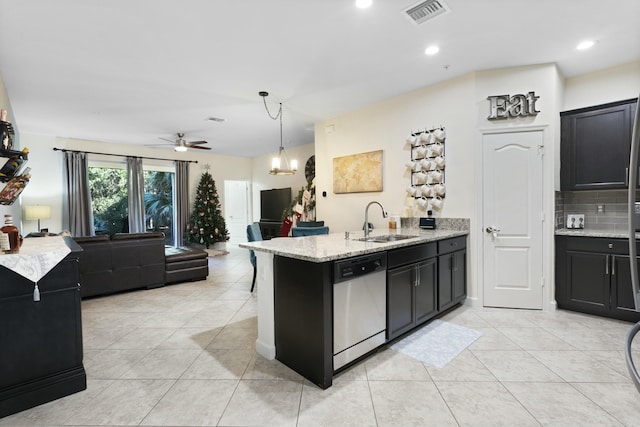 kitchen featuring dishwasher, ceiling fan with notable chandelier, sink, decorative backsplash, and decorative light fixtures