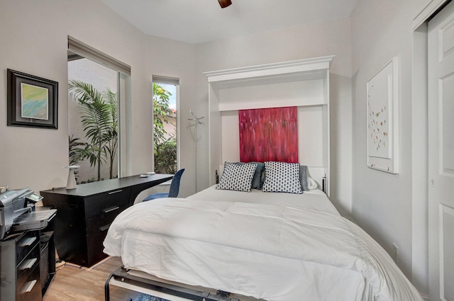 bedroom featuring wood-type flooring, a closet, and ceiling fan