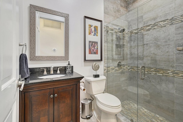 bathroom with vanity, toilet, and an enclosed shower