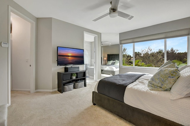 carpeted bedroom featuring connected bathroom and ceiling fan