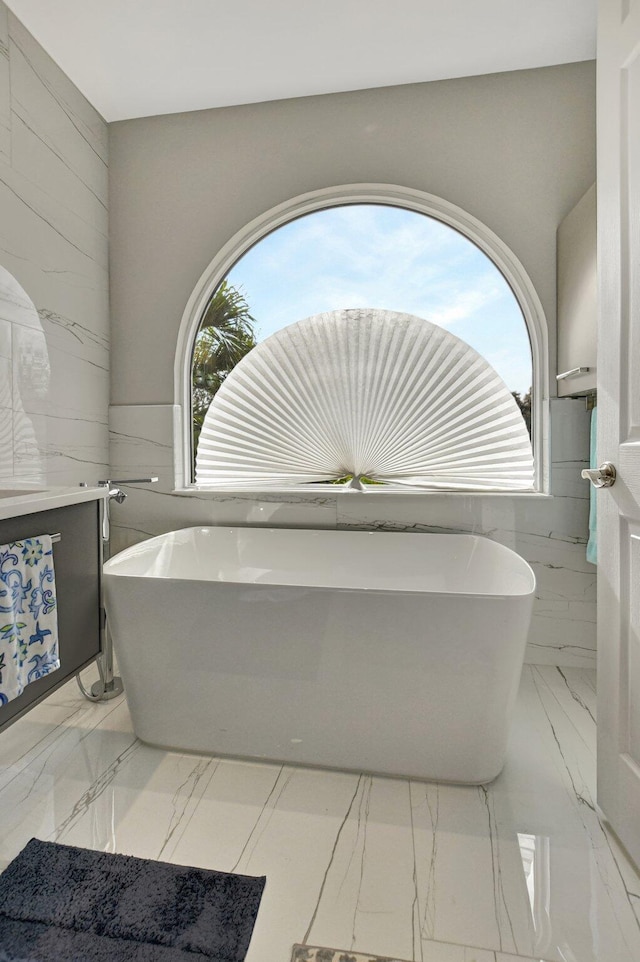 bathroom with a bathtub and tile walls