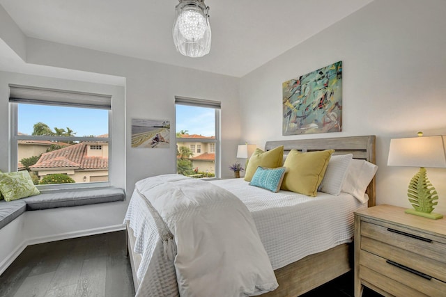 bedroom with dark hardwood / wood-style floors