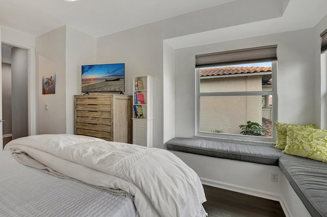 bedroom with dark wood-type flooring