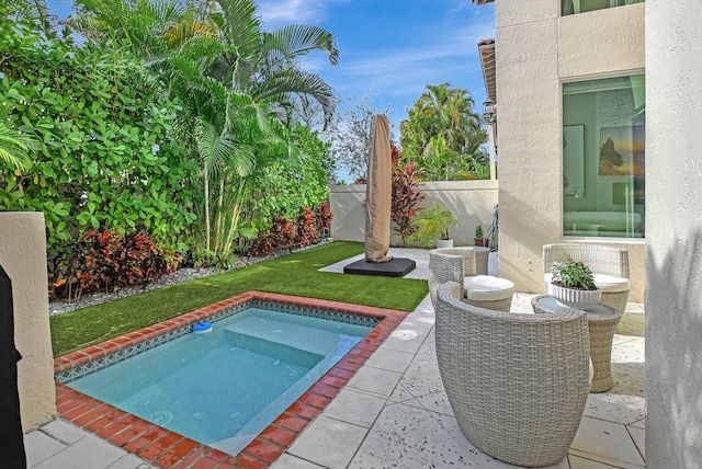 view of pool with a yard and a hot tub