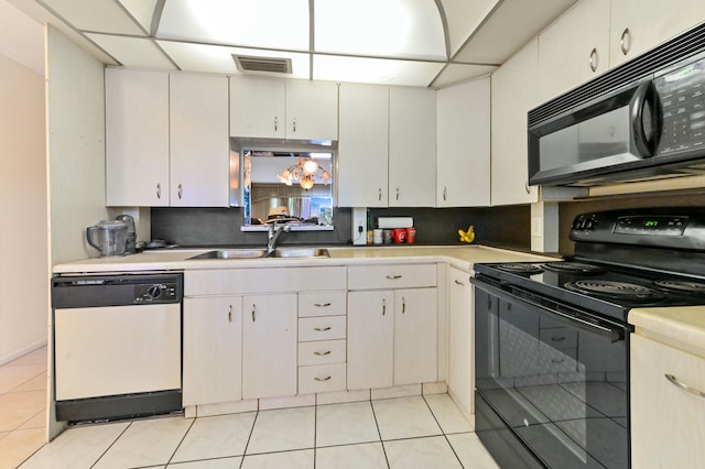 kitchen featuring white cabinets, sink, light tile patterned floors, and black appliances