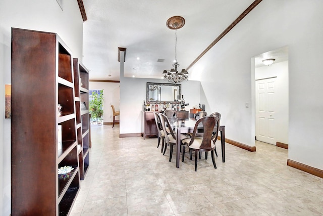 dining area with crown molding, light tile patterned floors, and a chandelier