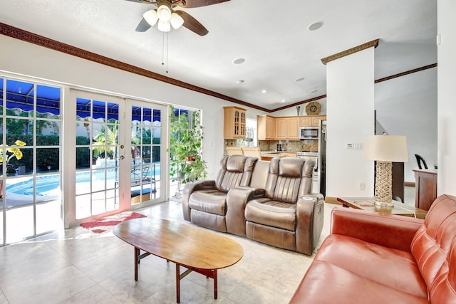 living room with french doors, ornamental molding, ceiling fan, light tile patterned floors, and lofted ceiling