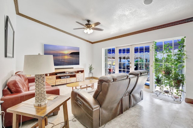 living room with lofted ceiling, french doors, crown molding, ceiling fan, and a textured ceiling