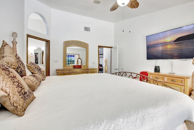 bedroom with a towering ceiling and ceiling fan