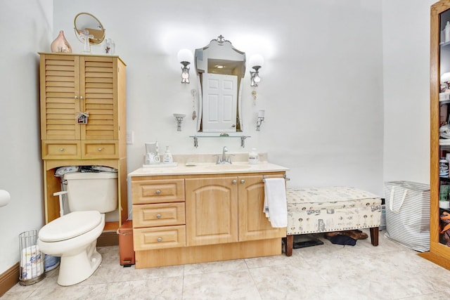 bathroom featuring tile patterned floors, vanity, and toilet