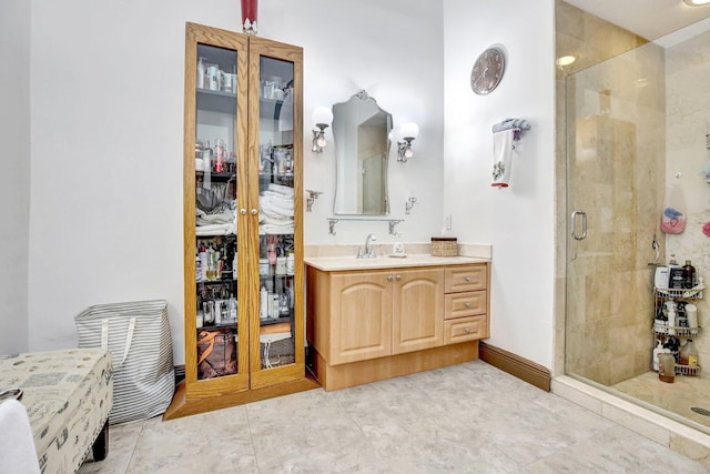 bathroom with vanity, tile patterned floors, and a shower with door